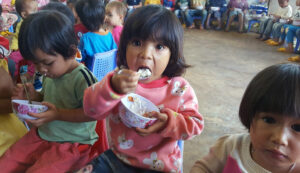 Children eat a nutritious meal at a daycare center in Vietnam