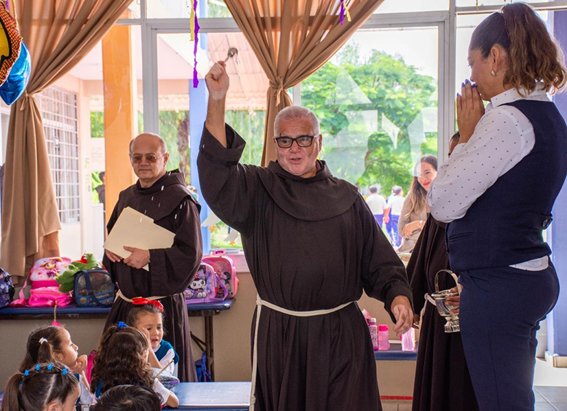Fr blessing the classroom in Margil School