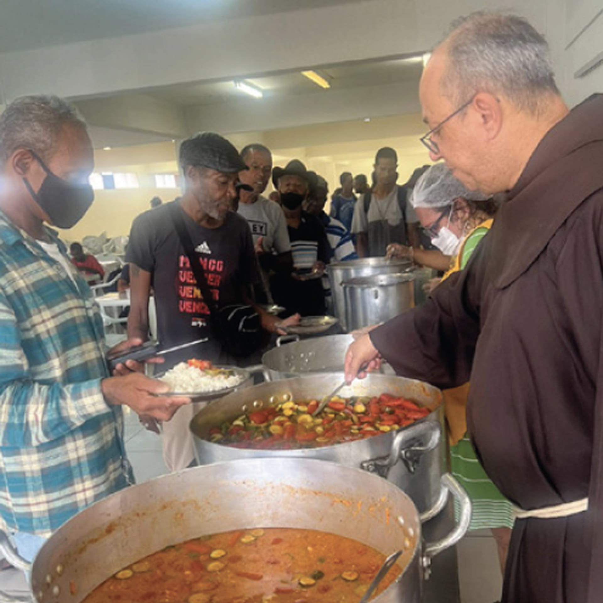 Franciscan missionary baptizes a child in the Amazons of Brazil