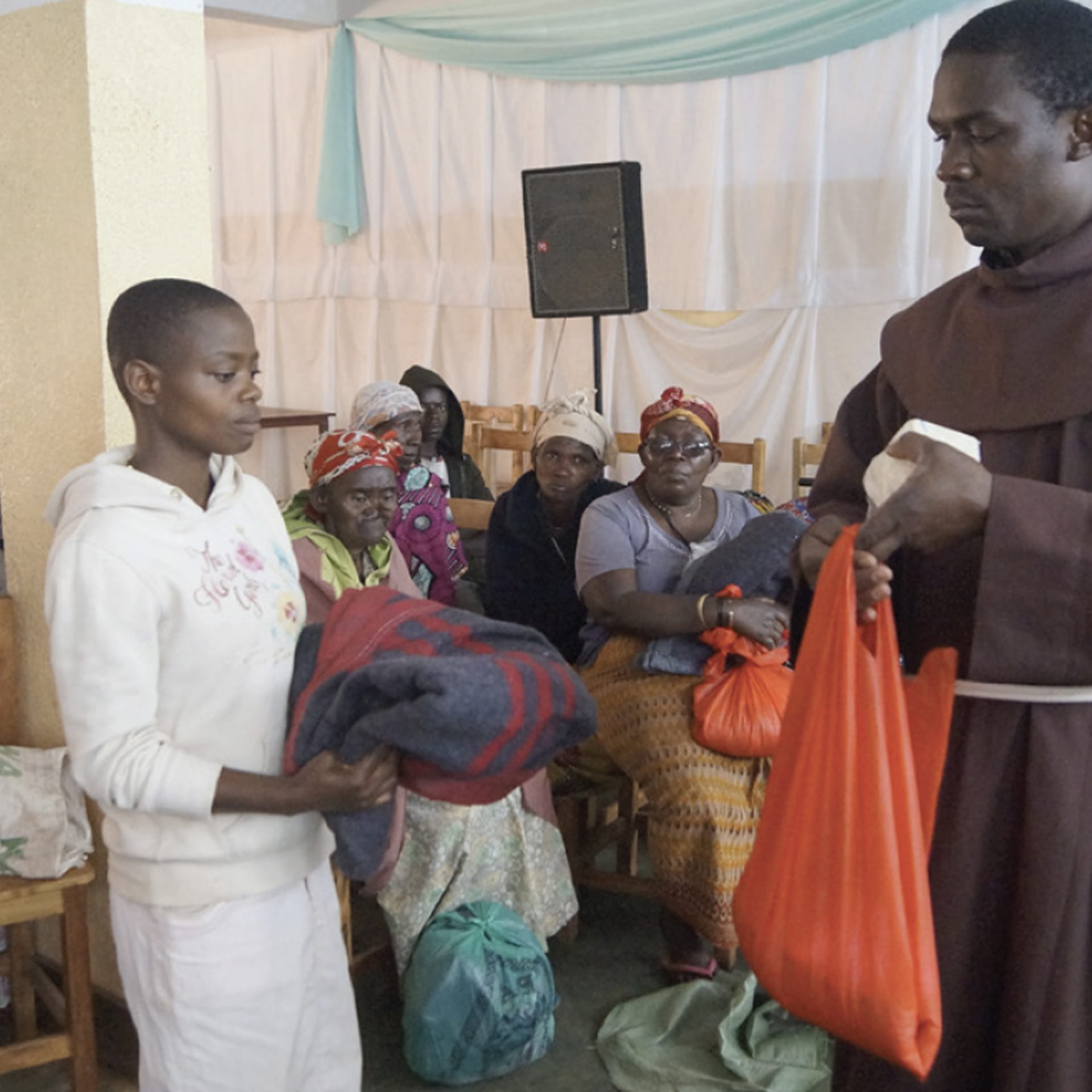 Franciscan missionary baptizes a child in the Amazons of Brazil